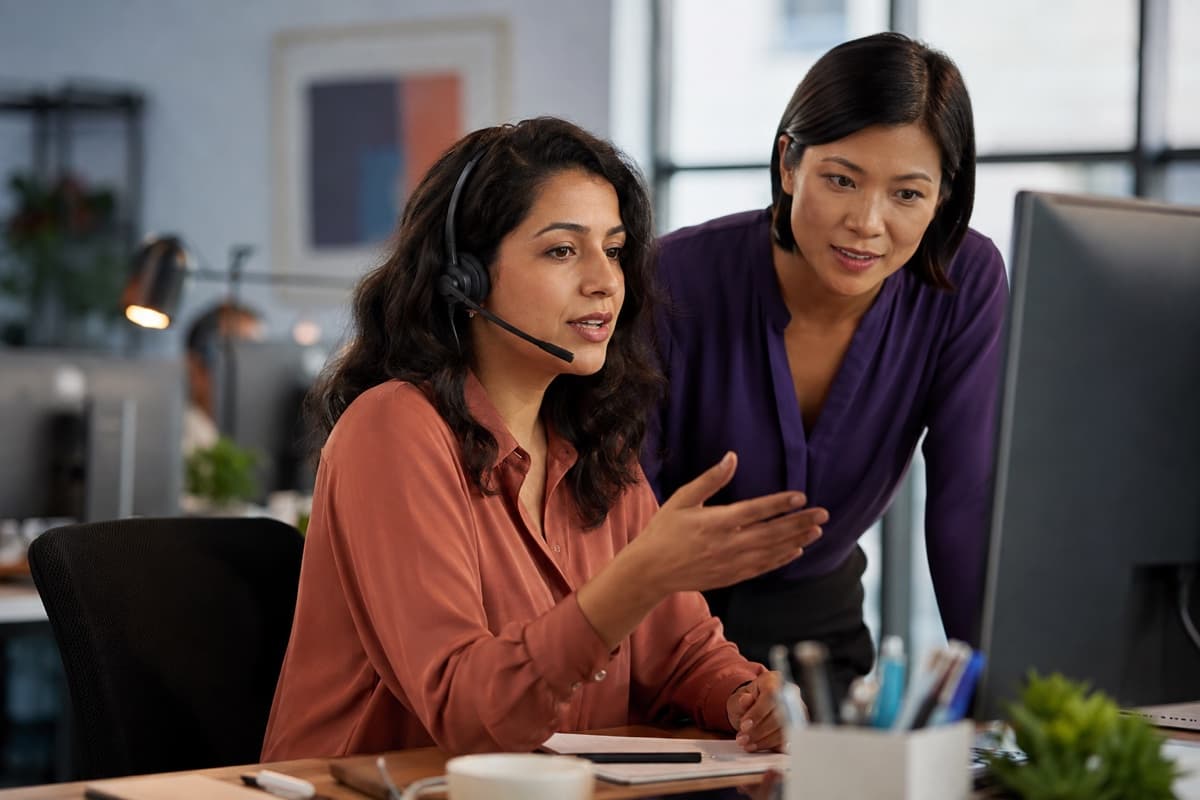 A team member in conversation with a colleague, representing the start of a direct conversation with Nextryzer
