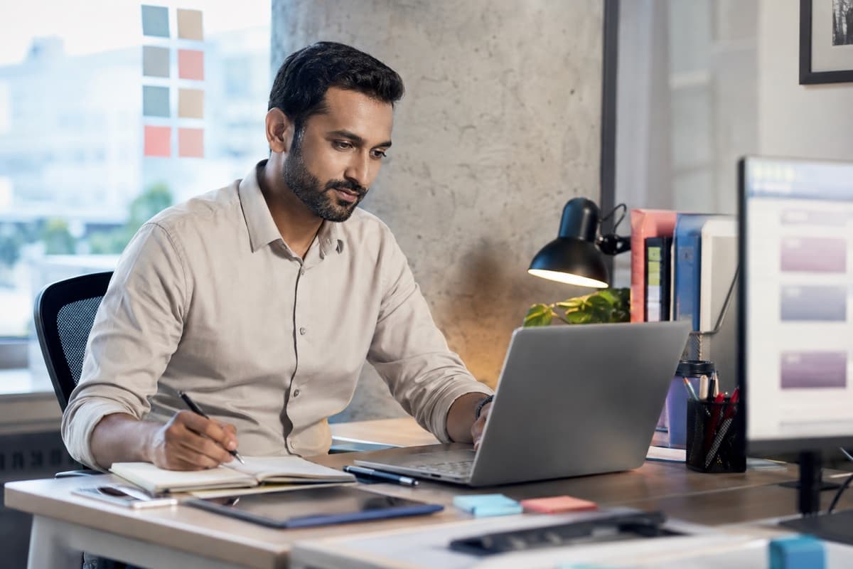 A focused team member working through a problem at their desk, representing the kind of careful, curious work Nextryzer values